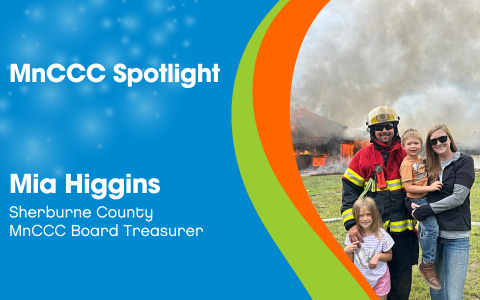 MnCCC Spotlight Mia Higgins, Sherburne County, MnCCC Board Treasurer. A photo of Mia posing with her family in front of a fire. The design features a blue background with faint sparkles and decorative green and orange lines.
